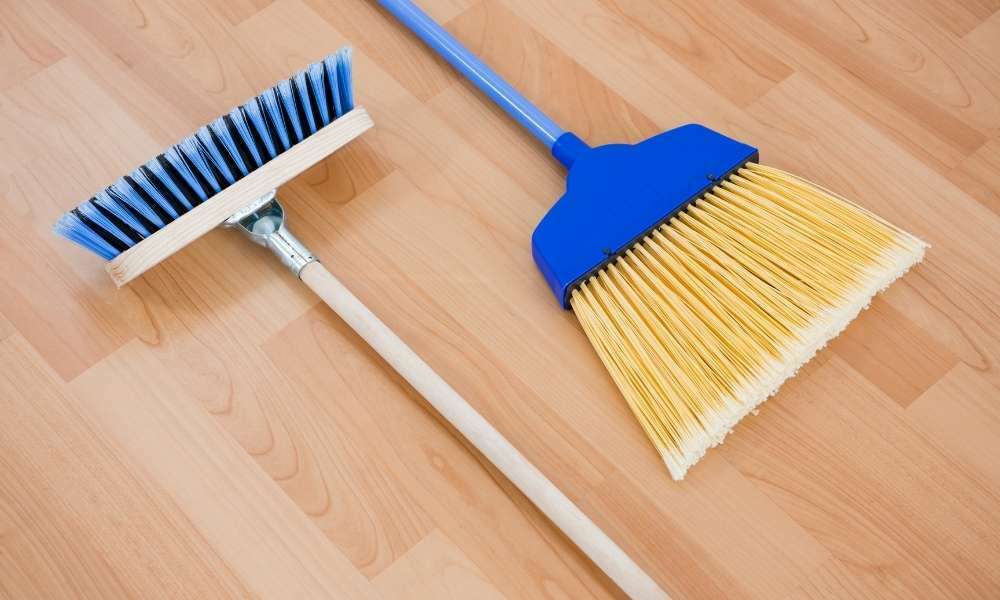 Sweep a Broom Handle To Clean Under Appliances