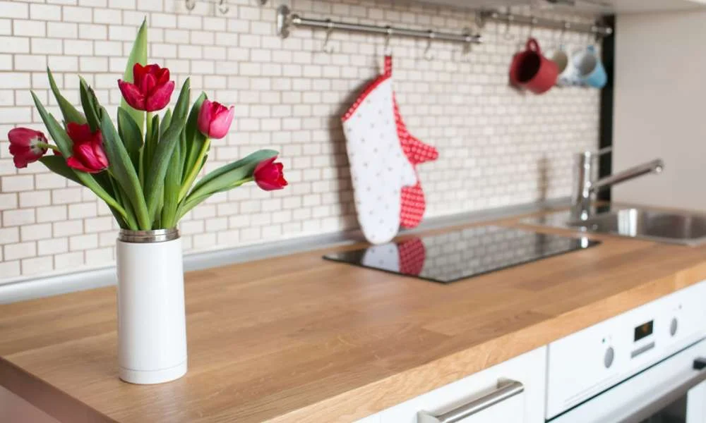 Add Plants or Flowers to The Kitchen to Lighten Up a Kitchen With Cherry Cabinets